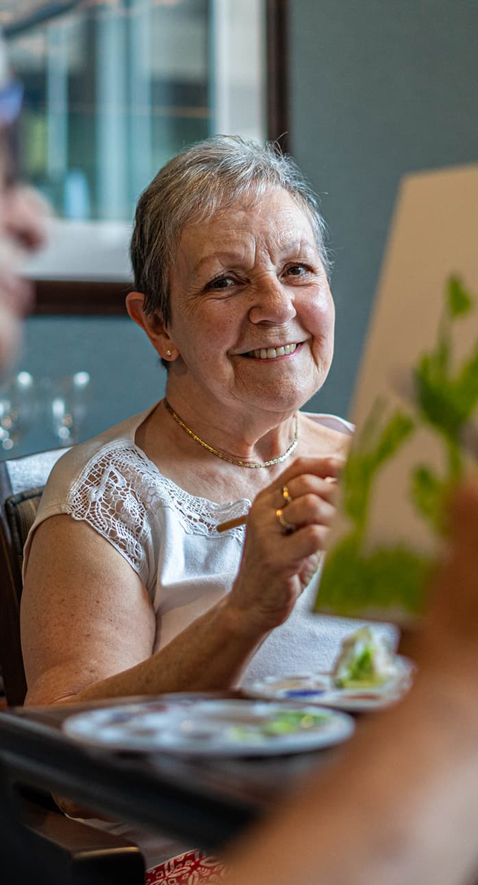 Verve senior resident smiling at dining table